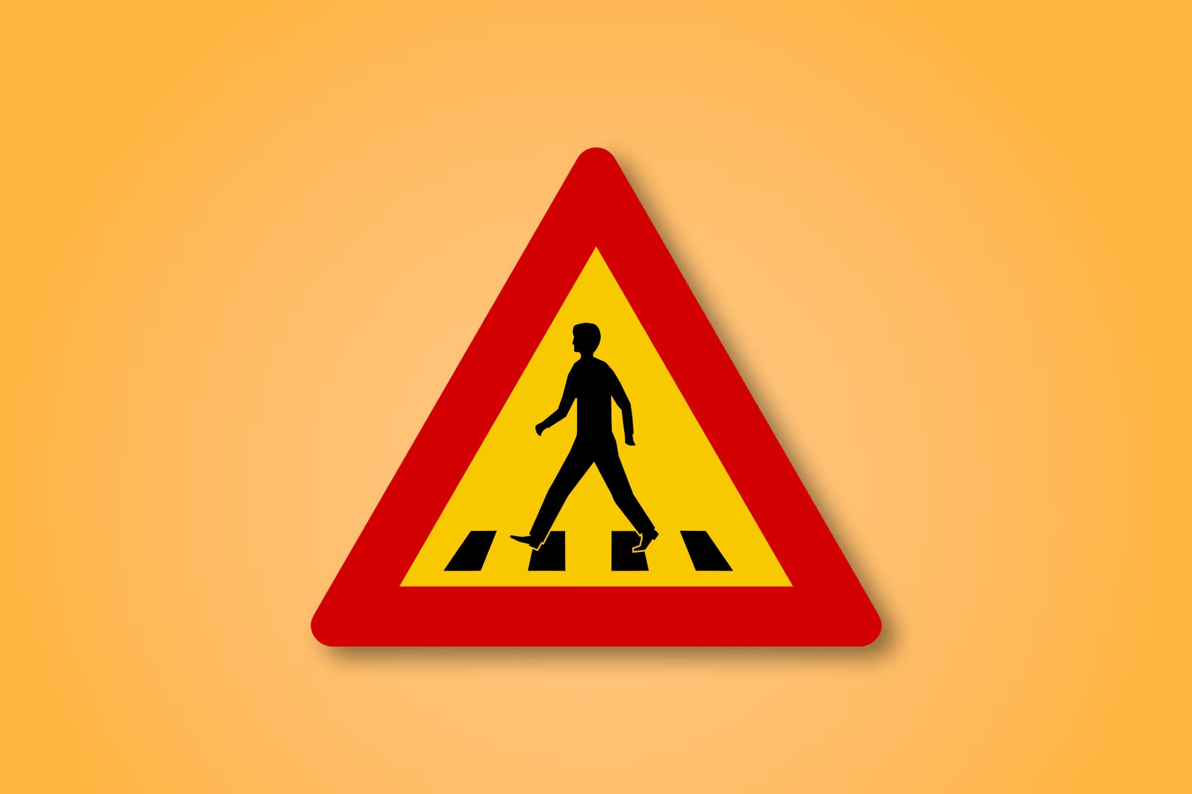 a yellow and red triangle sign with a man walking on a crosswalk .