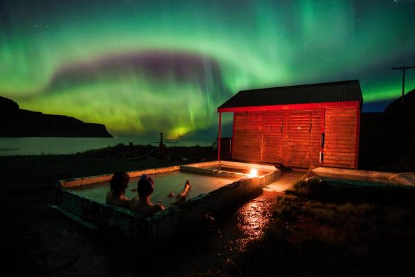 Hot Spring Relaxing in hot spring in iceland under northen lights