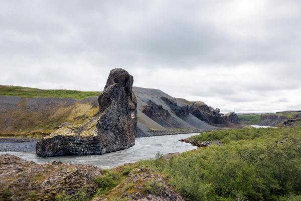 there is a large rock in the middle of a river .