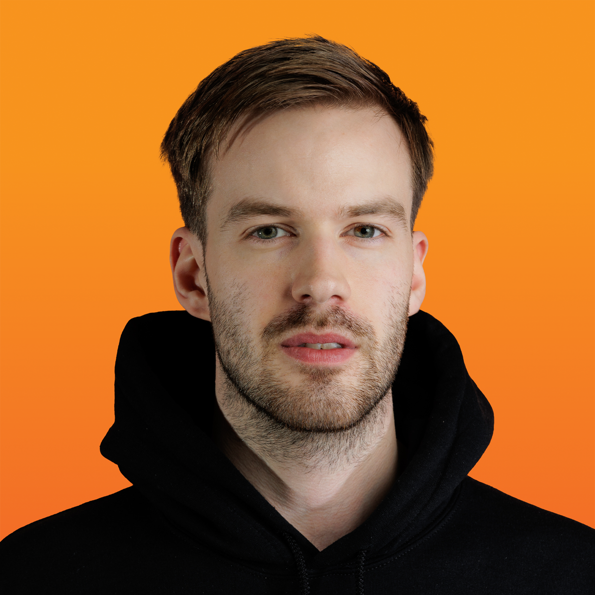 a man with a beard is wearing a black hoodie