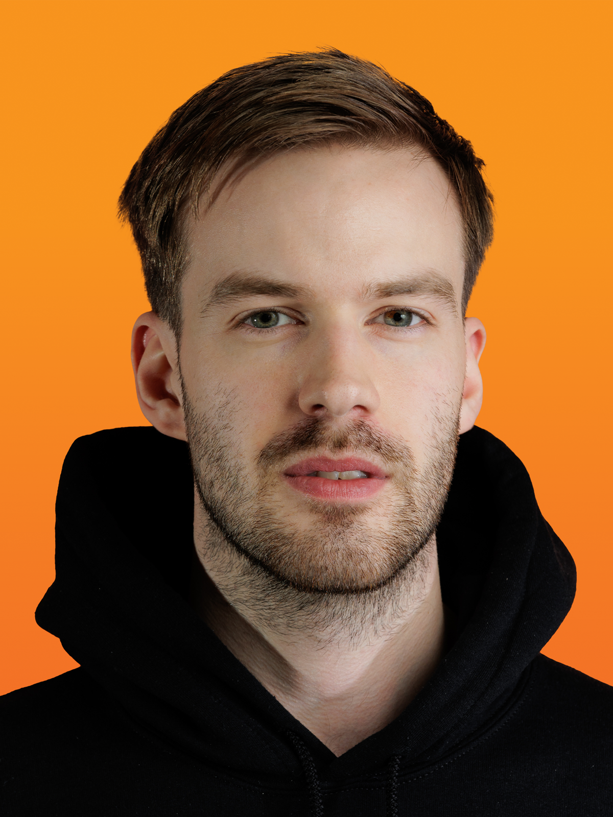 a man with a beard is wearing a black hoodie