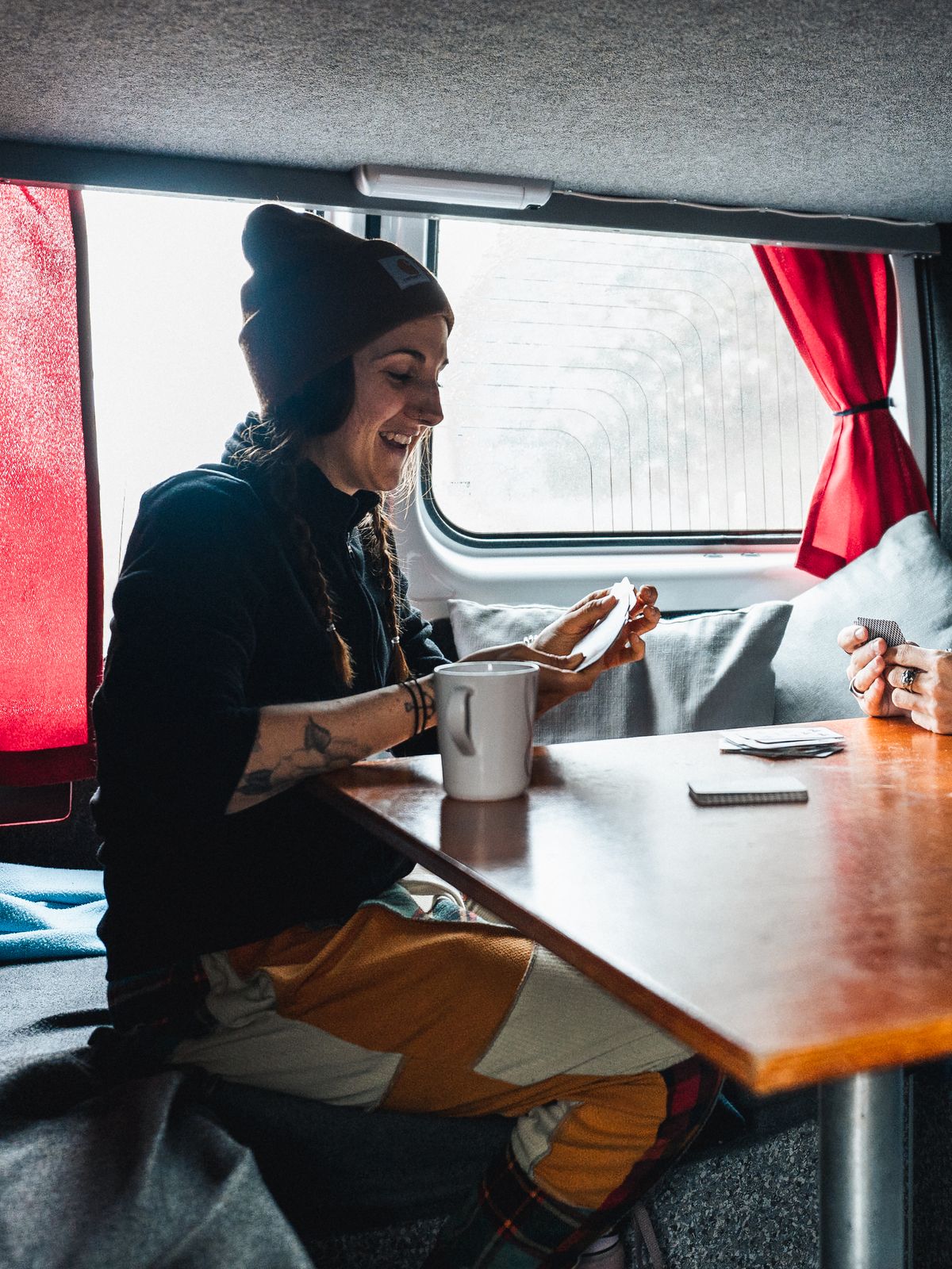 a man and a woman are sitting at a table in a van .