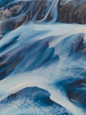 an aerial view of a river flowing through a rocky landscape in the highlands in iceland.