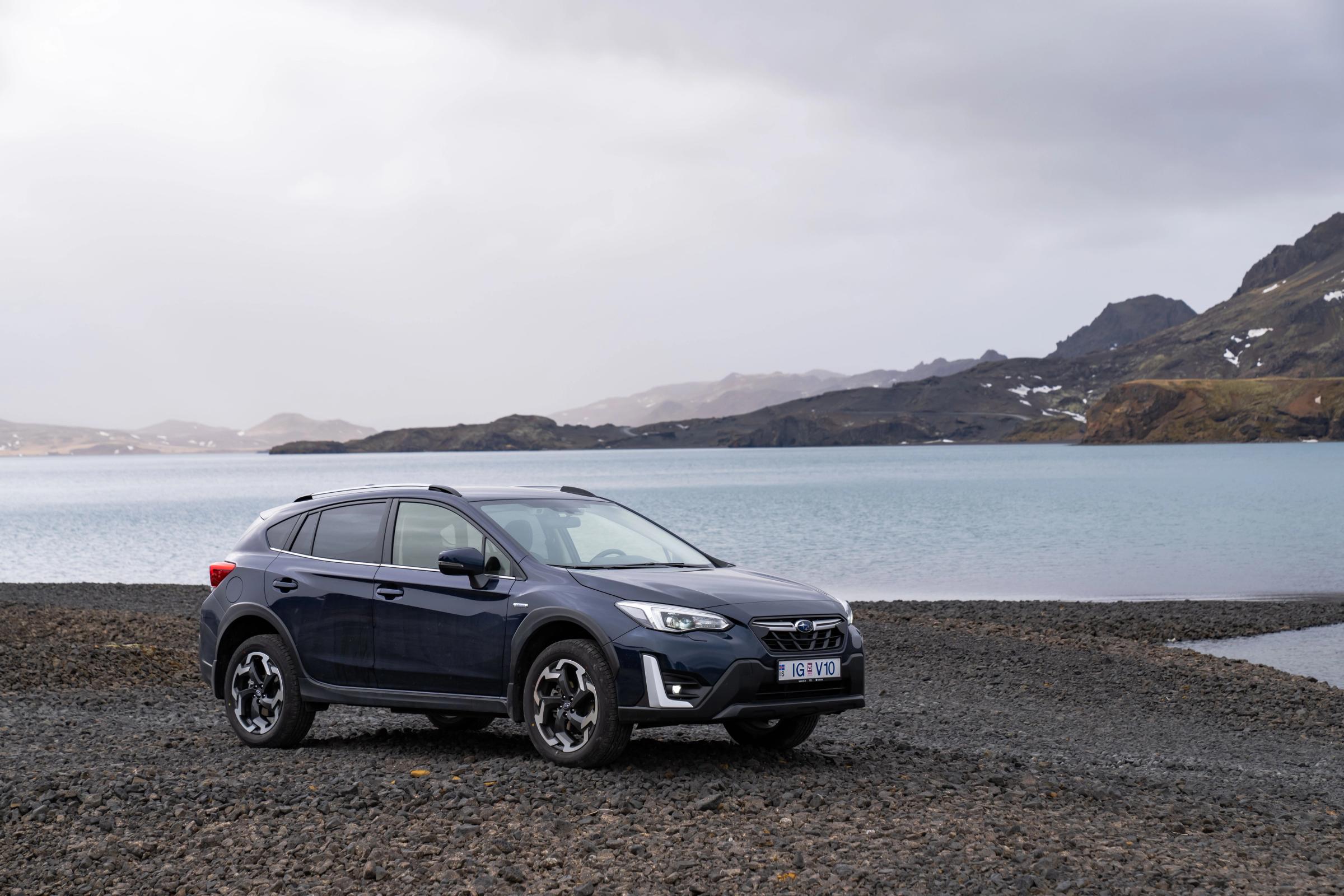 a subaru rental car parked near the sea in Iceland
