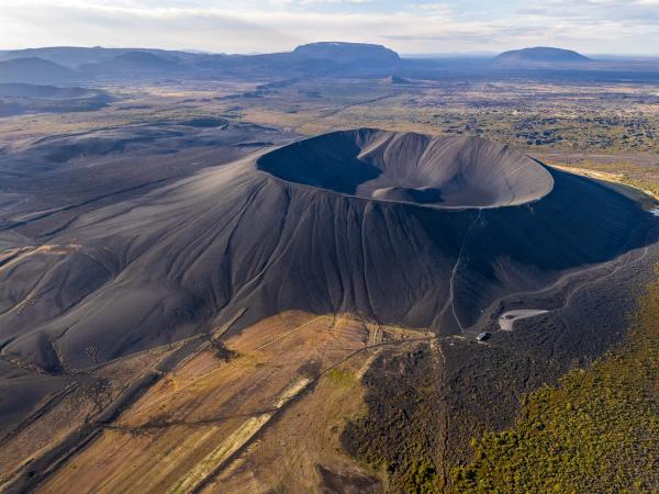 a black crater on a vast field