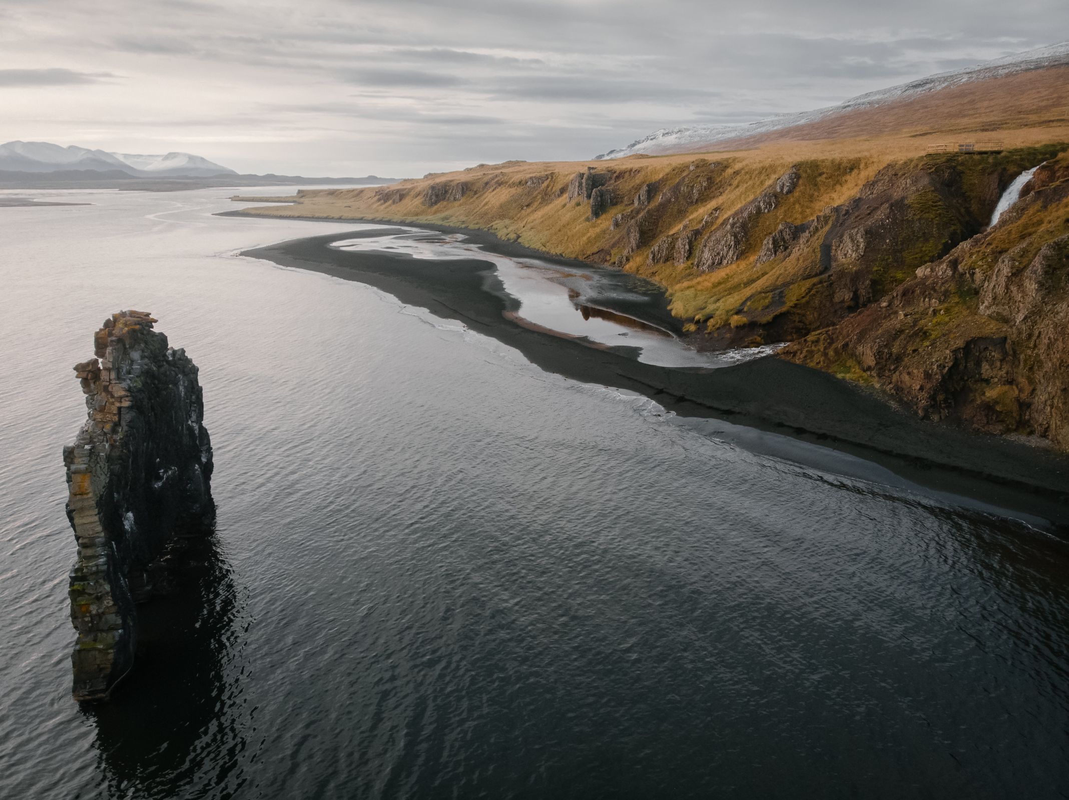 there is a large rock in the middle of the ocean .
