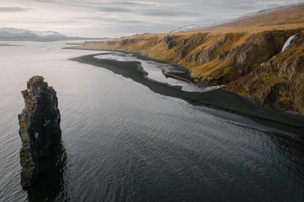 there is a large rock in the middle of the ocean .