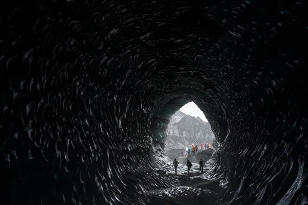 Three people inside the Katla Ice Cave