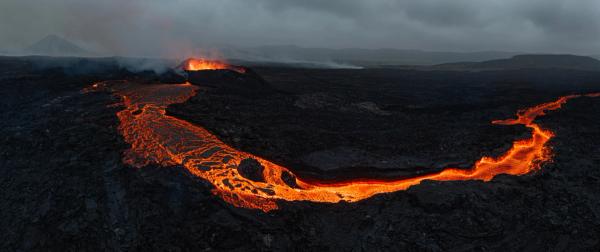 an aerial view of Litli-Hrutur volcano with lava coming out of it .