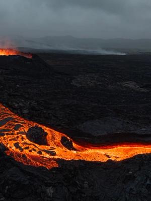 an aerial view of Litli-Hrutur volcano with lava coming out of it .
