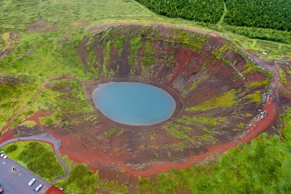 an aerial view of a small lake in the middle of a field .