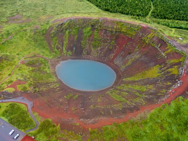 an aerial view of a small lake in the middle of a field .