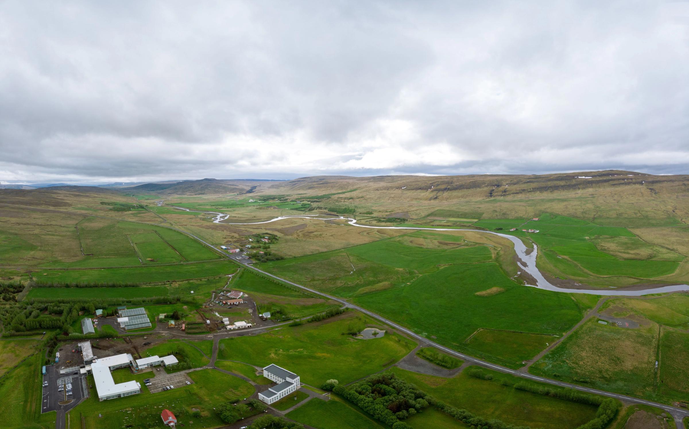 Aerial panoramic view of a small town in the middle a vast field