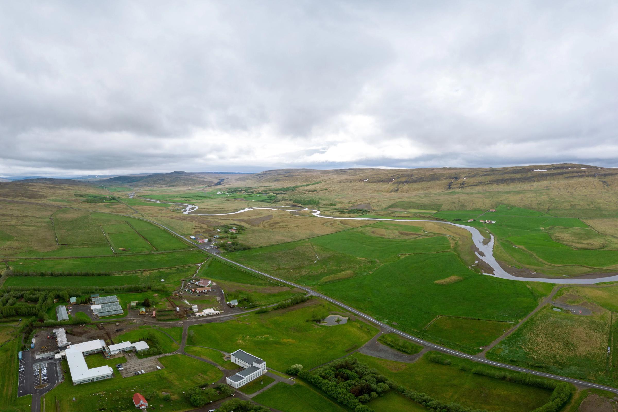 Aerial panoramic view of a small town in the middle a vast field