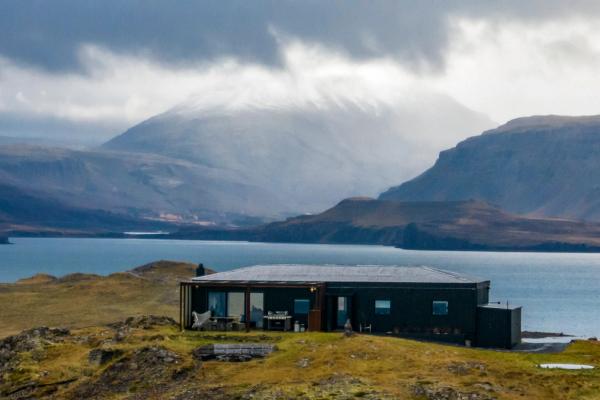 panoramic of a fiord with a house on the foreground