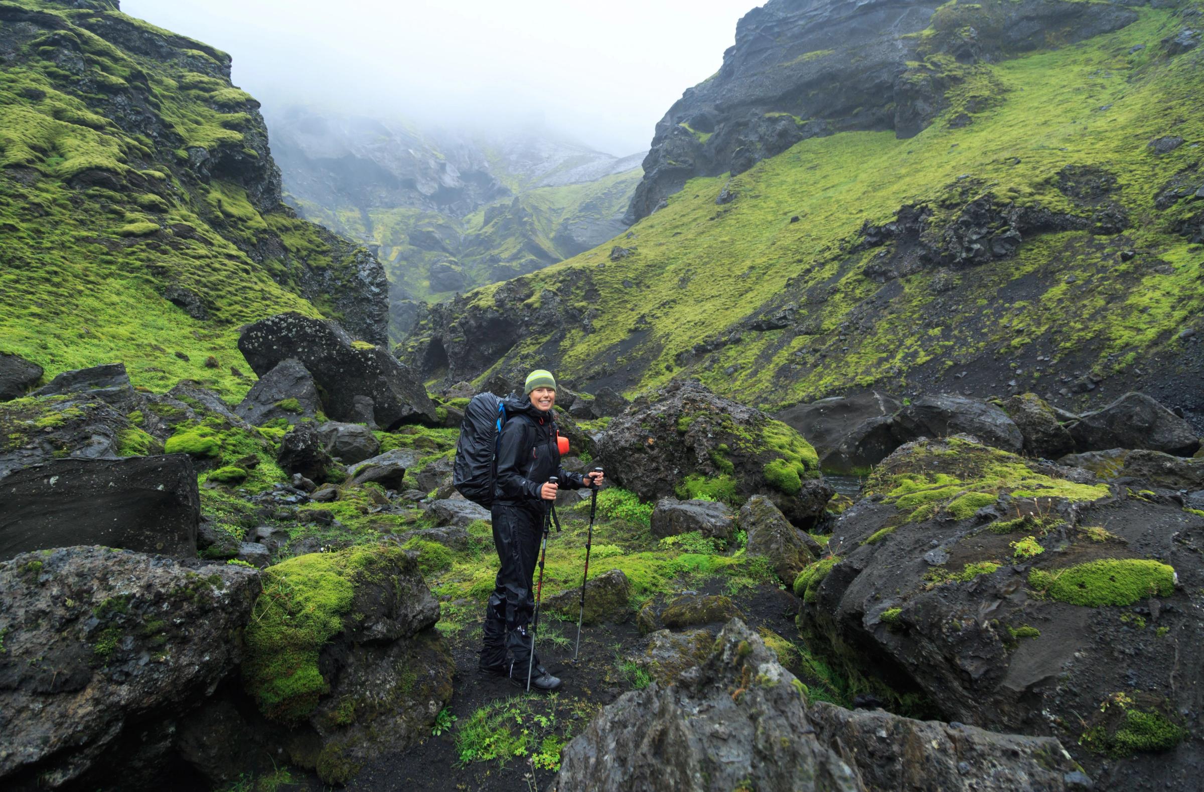 Hiker walking on a trail in Iceland's glacial river canyons