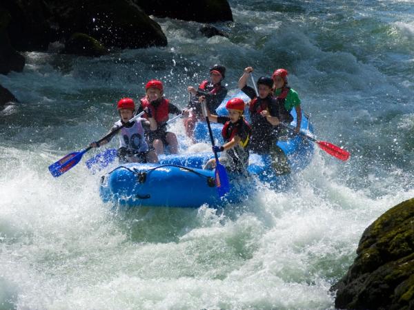 Group of friends river rafting in iceland