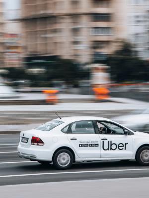 Coche blanco de Uber en la carretera