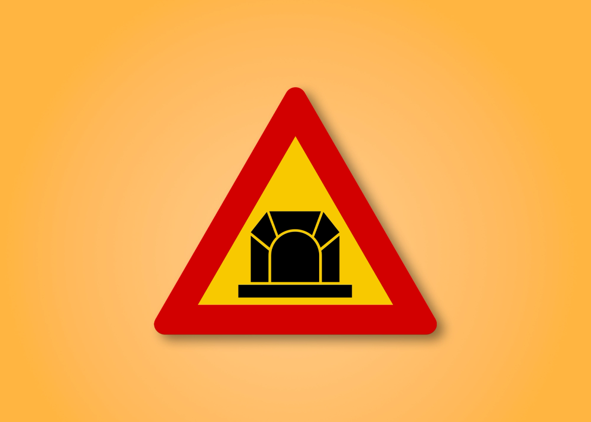 a yellow and red triangle sign with a bridge on it