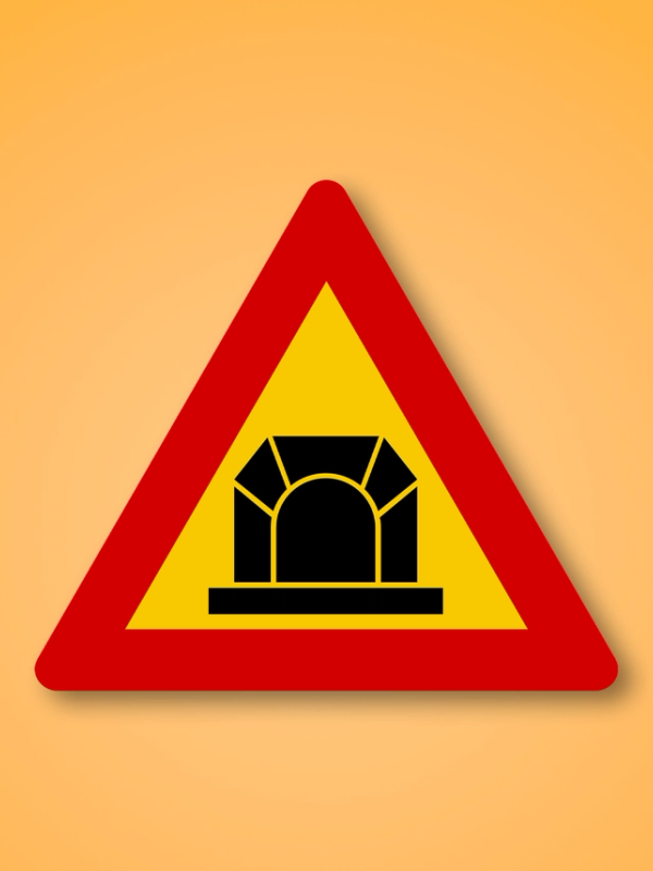 a yellow and red triangle sign with a bridge on it