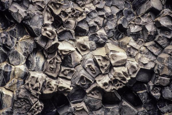 Dark, angular basalt columns with eroded, textured surfaces.