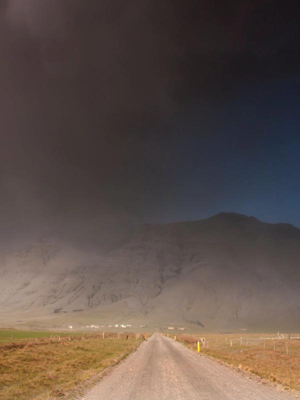 Sand Storm in Iceland that is covered by rental car insurance Sand and Ash Protection Sand and Ash storm in iceland near a gravel road in the F-roads