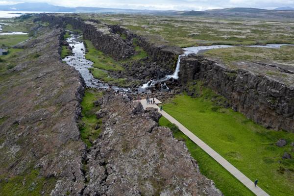 An aerial view of a waterfall between two tectonic plates