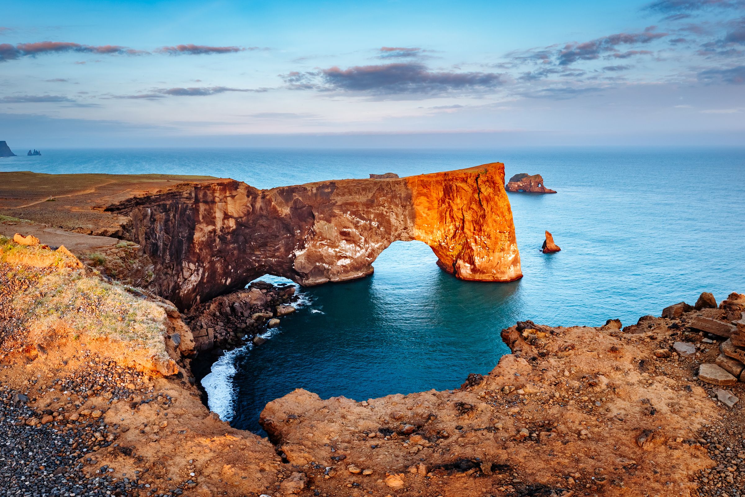 there is a large rock formation in the middle of the ocean .