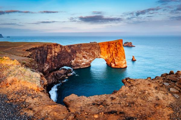there is a large rock formation in the middle of the ocean .