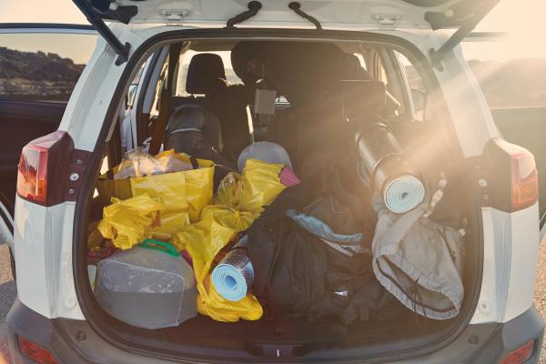 the trunk of a car is filled with a lot of luggage .