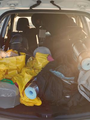the trunk of a car is filled with a lot of luggage .