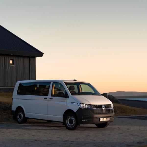 a white van is parked in front of a house .