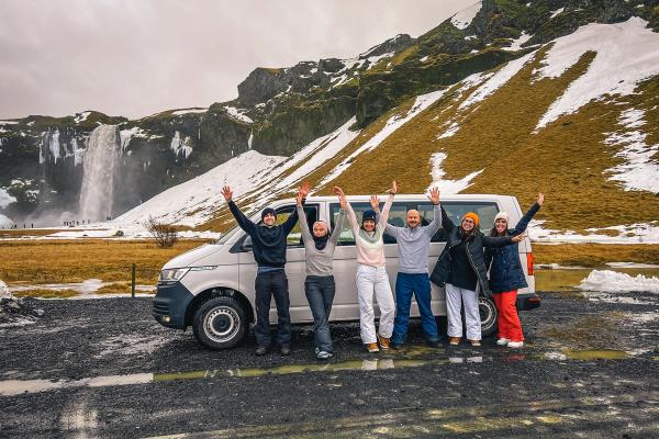 rental car van in iceland Group of happy people near a 9 seater rental car van in iceland