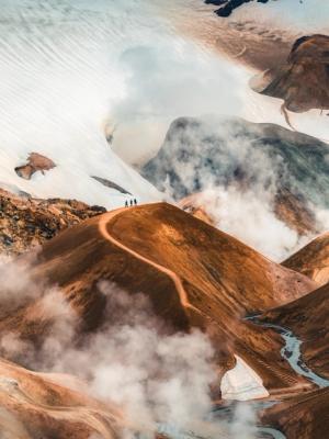 a group of people standing on top of a mountain surrounded by clouds at Kerlingafjöll in iceland.