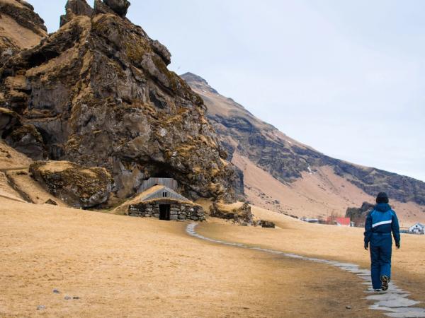 Man walking towards an elf house in Iceland