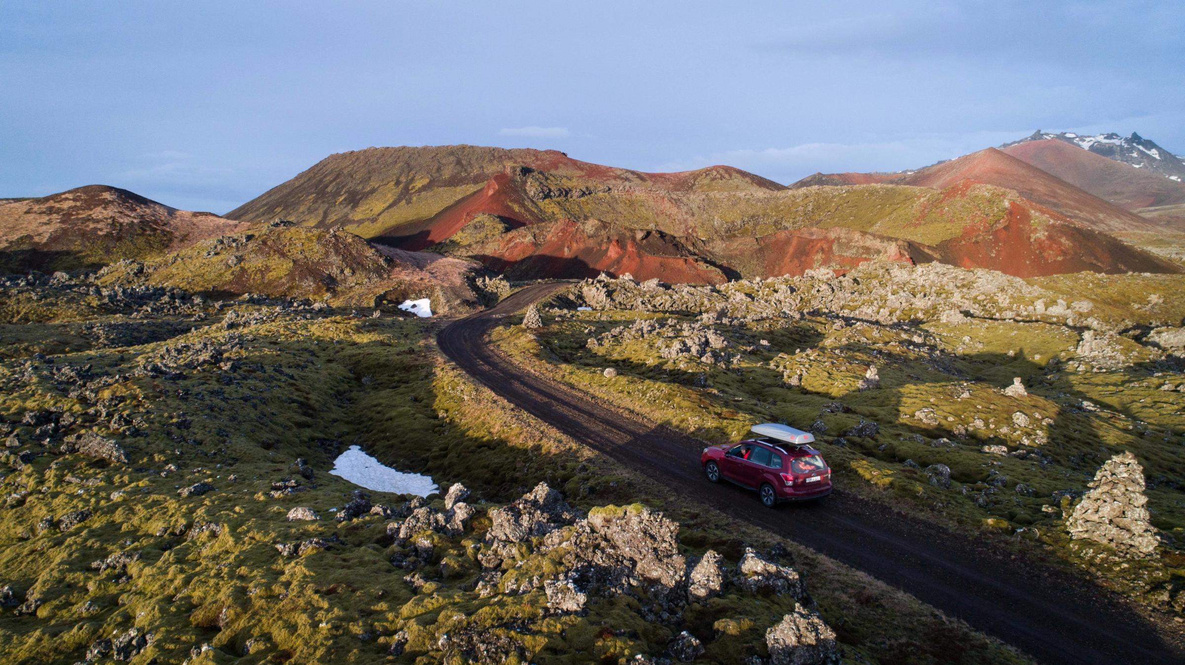 A subaru Forester SUV driving a F-road in a rugged terrain in Iceland 