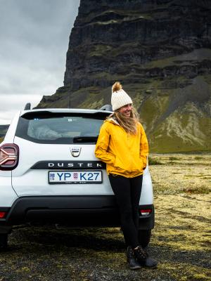 Dacia Duster to drive in Iceland Person standing in front of a Dacia Duster in Iceland