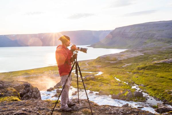 a photopgrapher taking pictures of Iceland's landscapes and its sunset