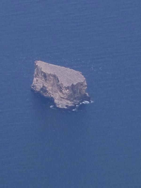 an aerial view of a small island in the middle of the ocean .