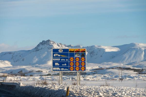 Speed limits in Iceland sign on Icelandic roads showing speed limits, picture taken in winter with view on snowy mountains in background