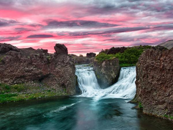 Hjálparfoss waterfall on a cloudy day