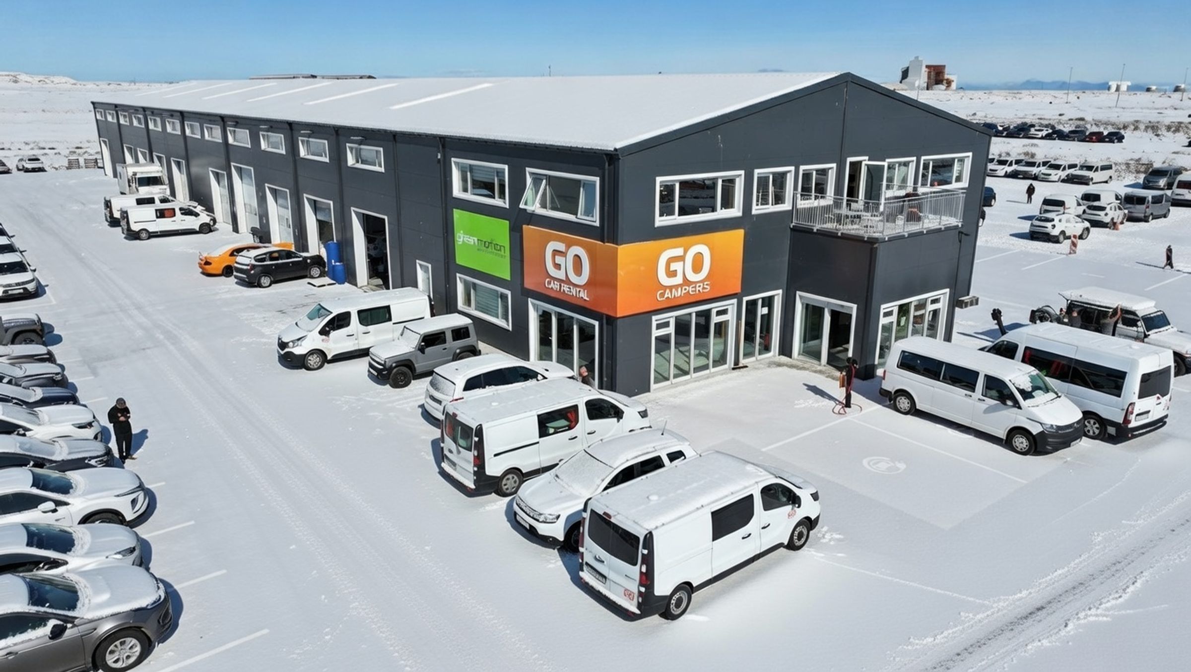 a large building with a lot of cars parked in front of it .