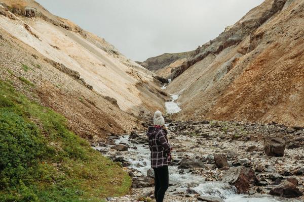Woman standing alone looking at a gorge