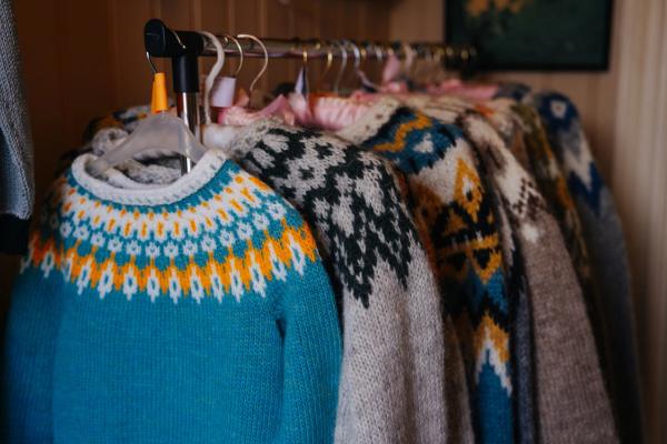 Many lopapeysa sweaters hanging of a rack