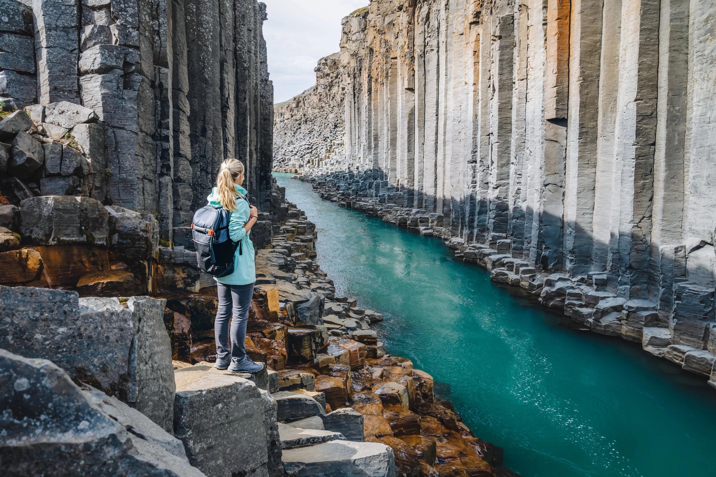Stuðlagil Canyon A woman standing on the bottom of Studlagil Canyon in iceland