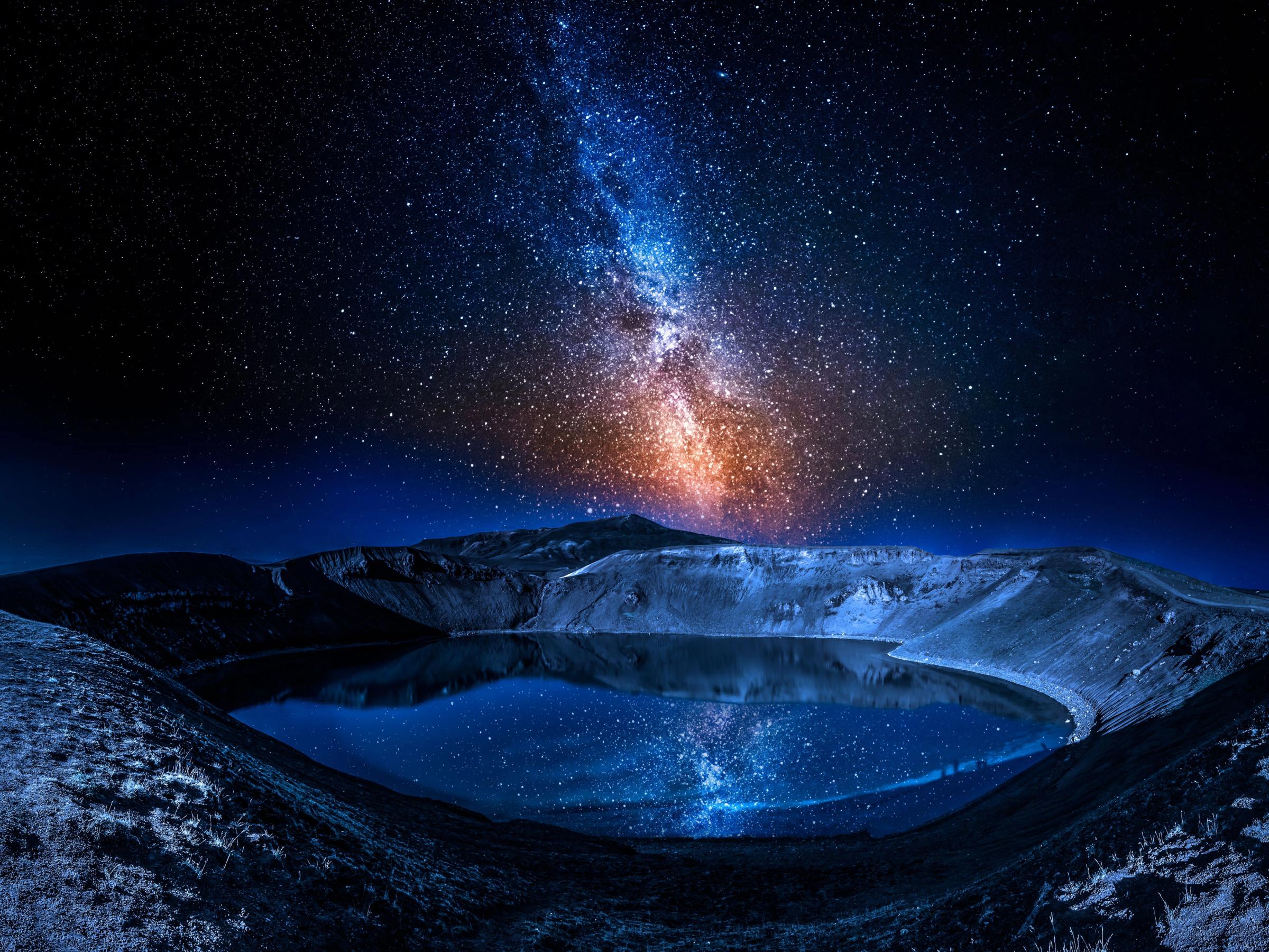 Volcano with a lake inside and thousands of stars in the sky, Iceland