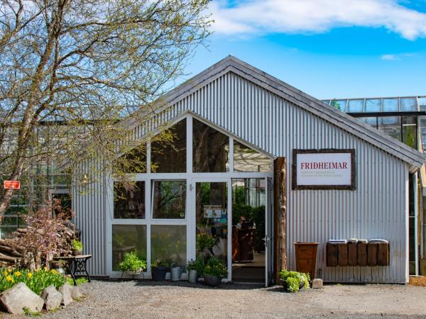 a large building with a lot of windows and plants in front of it .