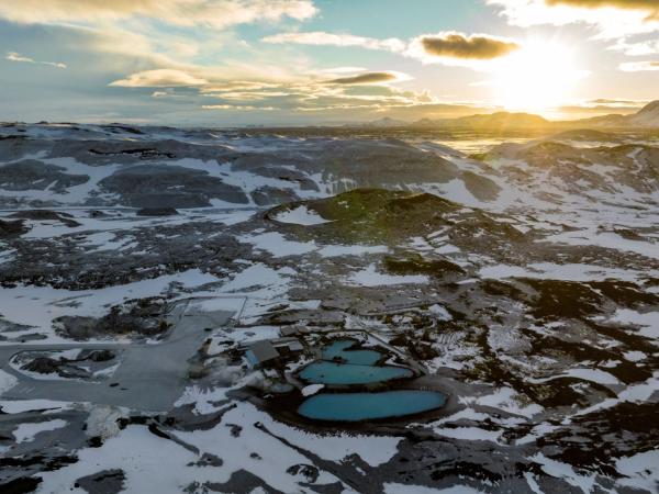 aerial view of Myvatn Nature Baths hot spring and the surroundings covered with snow during sunrise