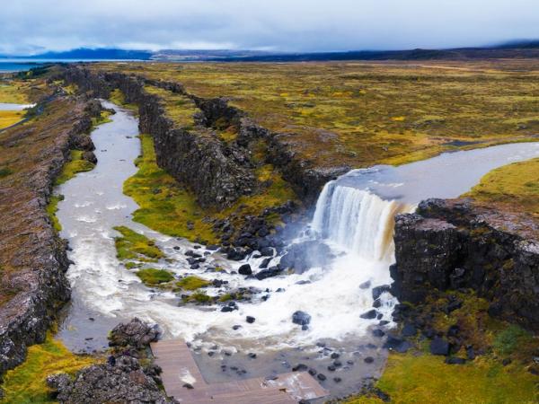 an aerial view of a waterfall in the middle of a field .