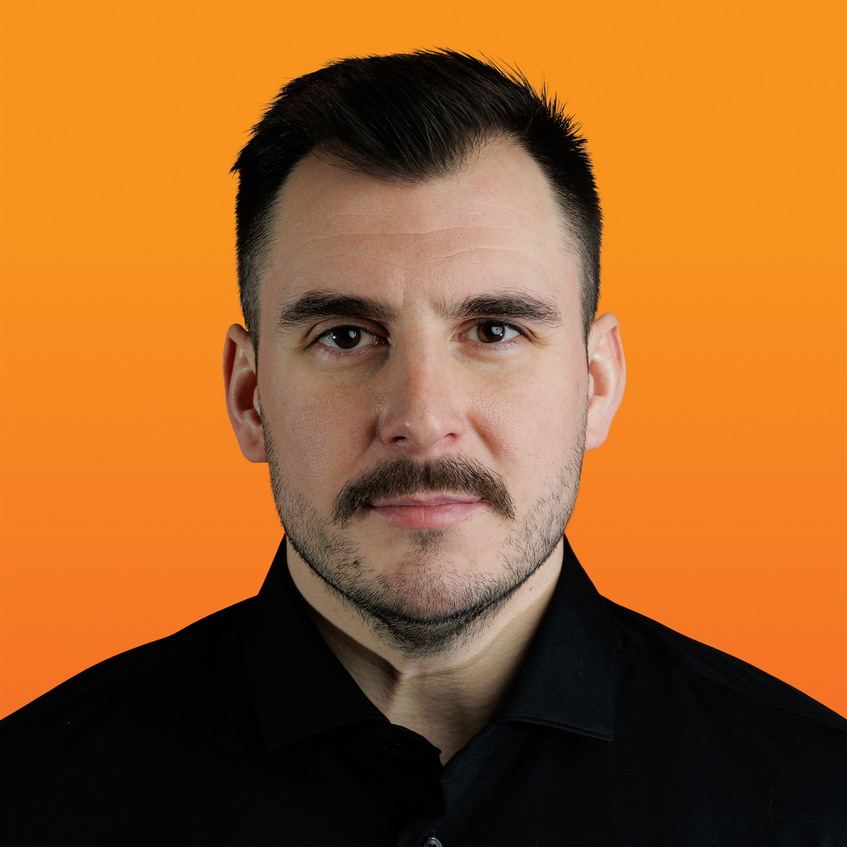 a man with a mustache is wearing a black shirt